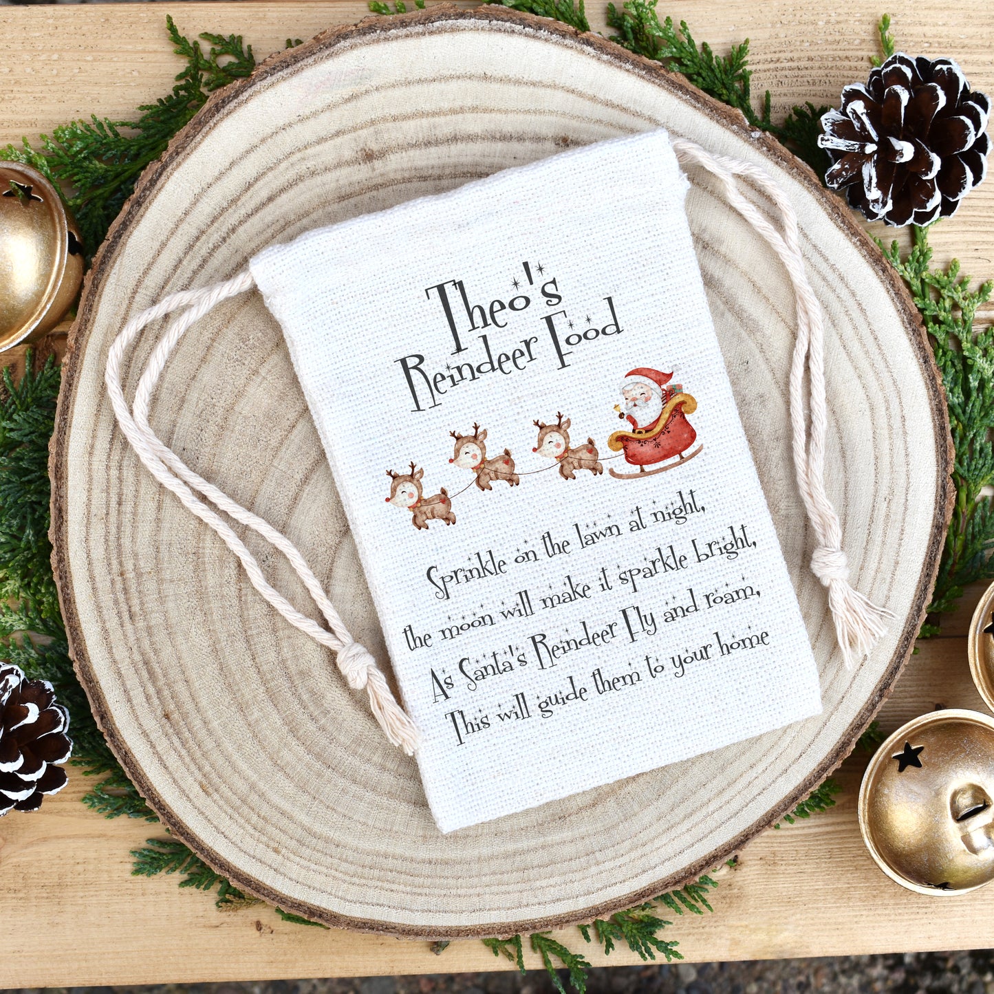 Image shows a personalised reindeer food drawstring pouch. The image is a cute Santa's sleigh in a watercolour style artwork. Above the Reindeer is the child's name which can be customised to one of your choosing. Underneath the reindeer is a poem of sprinkle on the lawn at night, the moon will make it sparkle bright, as Santa's Reindeer fly and roam, this will guide them to your home. The bag comes filled with wildlife friendly wild bird seed.